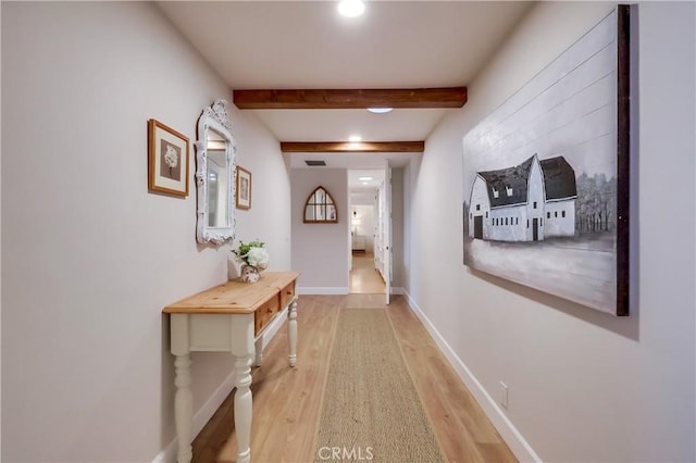 hall with visible vents, recessed lighting, light wood-style flooring, beamed ceiling, and baseboards