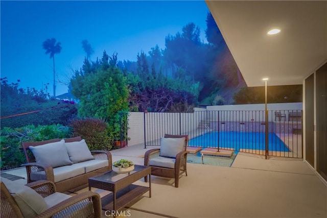 view of patio / terrace featuring fence, an outdoor living space, and a fenced in pool
