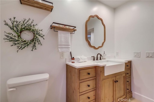half bath featuring toilet and vanity