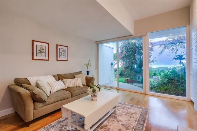living area featuring light wood-type flooring and visible vents