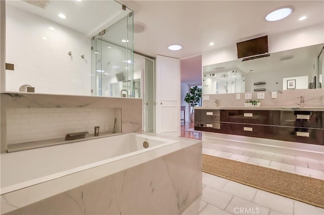 bathroom featuring visible vents, recessed lighting, a stall shower, double vanity, and a bath
