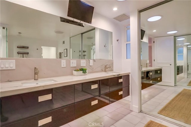 bathroom featuring a sink, visible vents, recessed lighting, tile patterned flooring, and double vanity