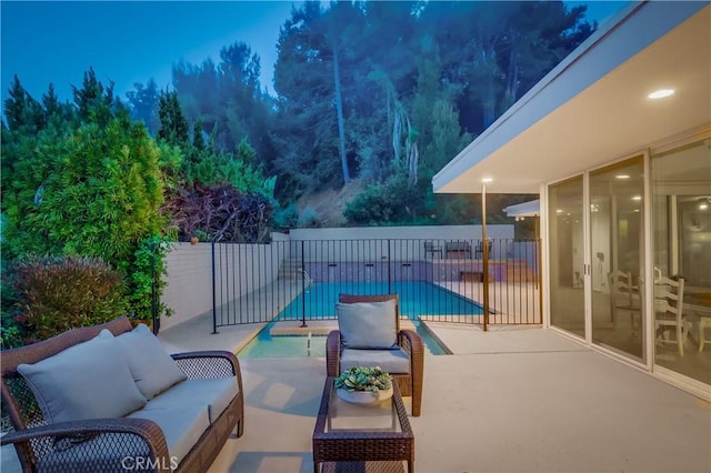 view of patio / terrace with fence, an outdoor living space, and a fenced in pool