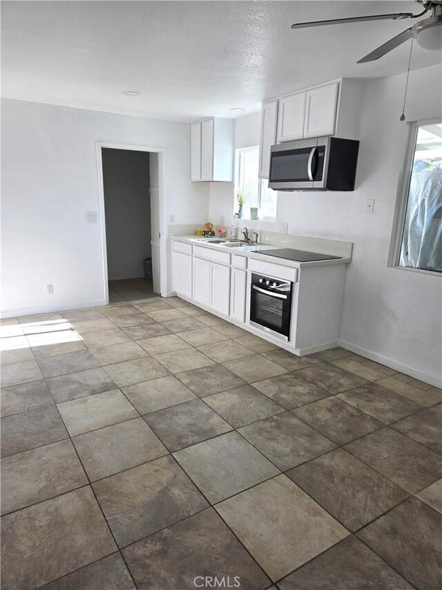 902 Boxwood Ln, Lemoore, CA 93245 - kitchen featuring stainless steel appliances, white cabinets, ceiling fan, and a sink