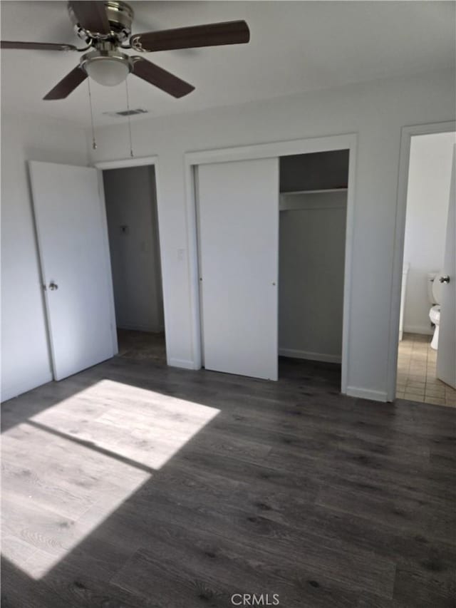 902 Boxwood Ln, Lemoore, CA 93245 - unfurnished bedroom with a closet, wood finished floors, a ceiling fan, and baseboards