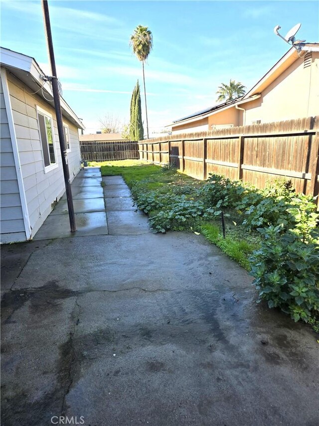 902 Boxwood Ln, Lemoore, CA 93245 - fenced backyard with a patio area