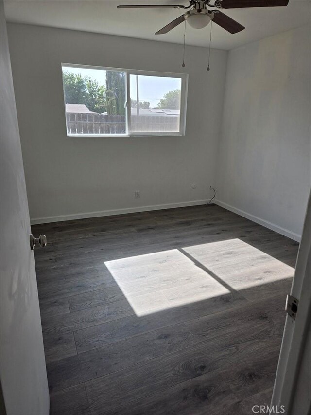 902 Boxwood Ln, Lemoore, CA 93245 - empty room with plenty of natural light, ceiling fan, wood finished floors, and baseboards