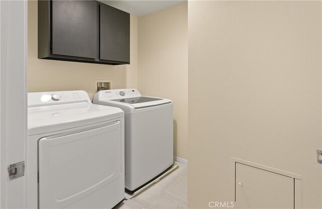 615 Rockefeller, Irvine, CA 92612 - washroom featuring cabinet space, independent washer and dryer, and light tile patterned flooring