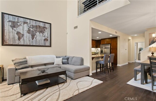 615 Rockefeller, Irvine, CA 92612 - living room featuring dark wood finished floors, stairs, and recessed lighting