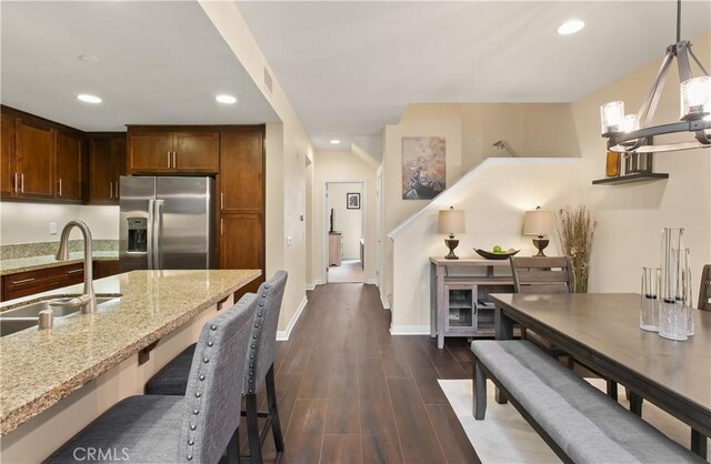 615 Rockefeller, Irvine, CA 92612 - kitchen with stainless steel refrigerator with ice dispenser, recessed lighting, dark wood finished floors, light stone countertops, and decorative light fixtures