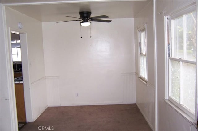 1208 W 23rd St, San Bernardino, CA 92405 - empty room featuring a ceiling fan, carpet flooring, and wainscoting