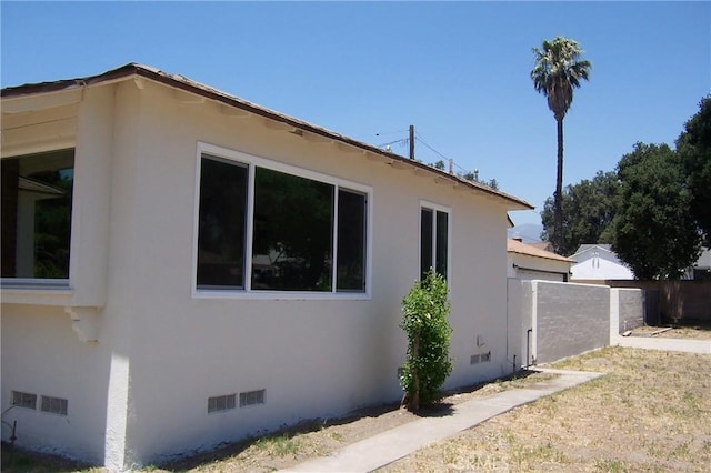 1208 W 23rd St, San Bernardino, CA 92405 - view of side of property featuring stucco siding and crawl space