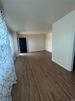 unfurnished living room with wood finished floors