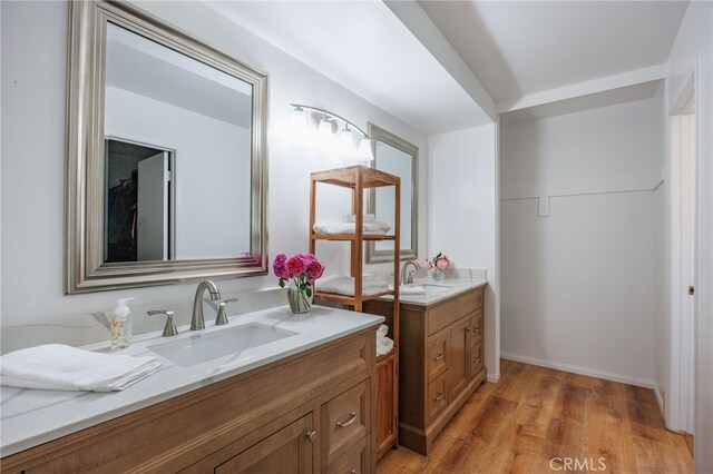 710 W Country Hills Dr W, La Habra, CA 90631 - bathroom featuring wood finished floors, a sink, and two vanities