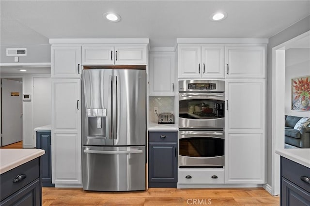 710 W Country Hills Dr W, La Habra, CA 90631 - kitchen featuring light countertops, stainless steel appliances, white cabinetry, and visible vents