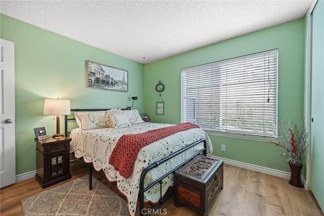 710 W Country Hills Dr W, La Habra, CA 90631 - bedroom featuring baseboards, a textured ceiling, and wood finished floors
