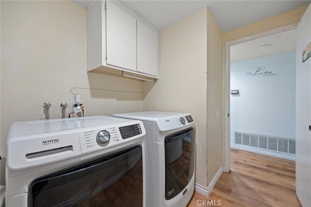 710 W Country Hills Dr W, La Habra, CA 90631 - clothes washing area featuring visible vents, washer and dryer, light wood-style floors, baseboards, and cabinet space