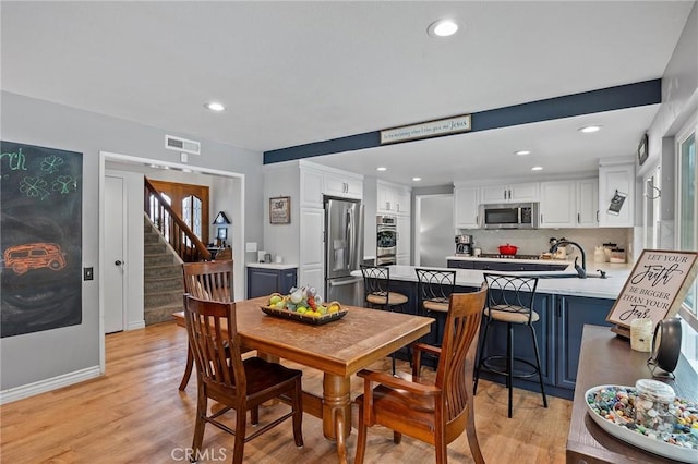 710 W Country Hills Dr W, La Habra, CA 90631 - dining space with visible vents, recessed lighting, light wood-style flooring, and stairway