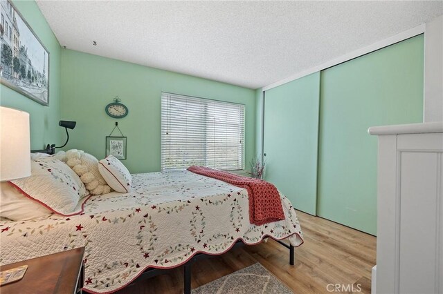 710 W Country Hills Dr W, La Habra, CA 90631 - bedroom featuring a textured ceiling, a closet, and wood finished floors