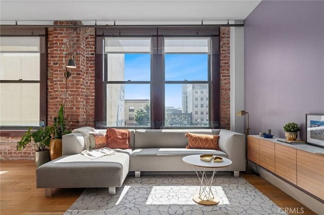 460 S Spring St Unit 302, Los Angeles, CA 90013 - living room with light wood-style floors and brick wall