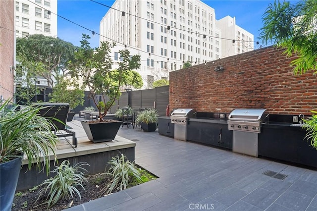 460 S Spring St Unit 302, Los Angeles, CA 90013 - view of patio / terrace featuring fence, exterior kitchen, and a grill