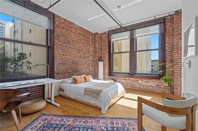 460 S Spring St Unit 302, Los Angeles, CA 90013 - bedroom with brick wall and wood-type flooring