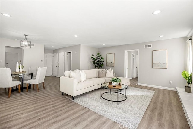 28 Brisbane Way, Irvine, CA 92612 - living area with light wood finished floors, a chandelier, and recessed lighting