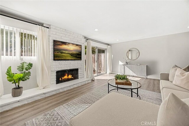 28 Brisbane Way, Irvine, CA 92612 - living area with a brick fireplace, wood finished floors, and recessed lighting