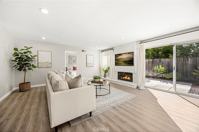 28 Brisbane Way, Irvine, CA 92612 - living area featuring wood finished floors, a fireplace, and recessed lighting