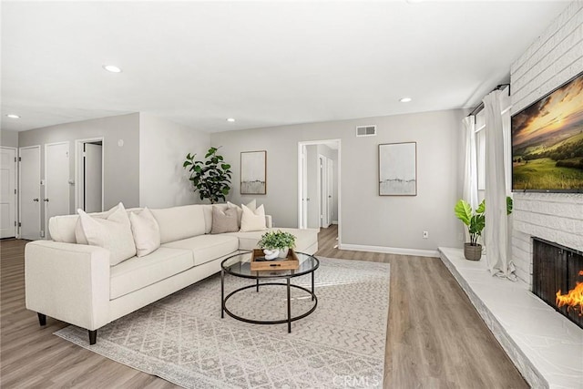28 Brisbane Way, Irvine, CA 92612 - living room with light wood finished floors, recessed lighting, and a fireplace