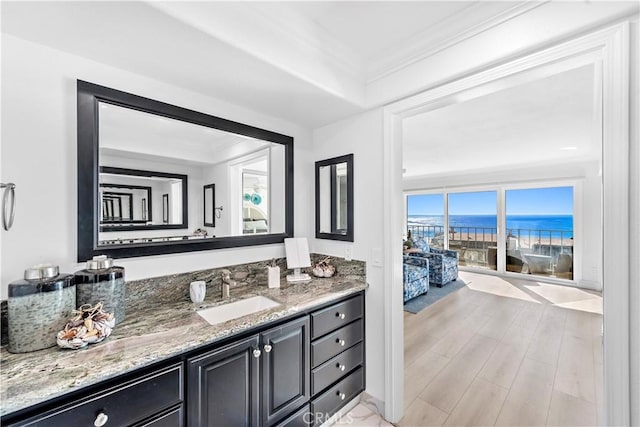 26056 Vista Dr E Unit 64, Dana Point, CA 92624 - bathroom with ornamental molding, vanity, wood finished floors, and a water view