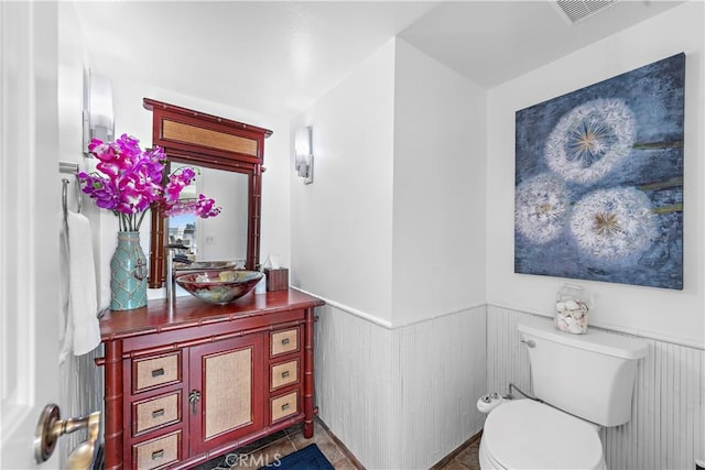26056 Vista Dr E Unit 64, Dana Point, CA 92624 - half bath with visible vents, toilet, vanity, and wainscoting