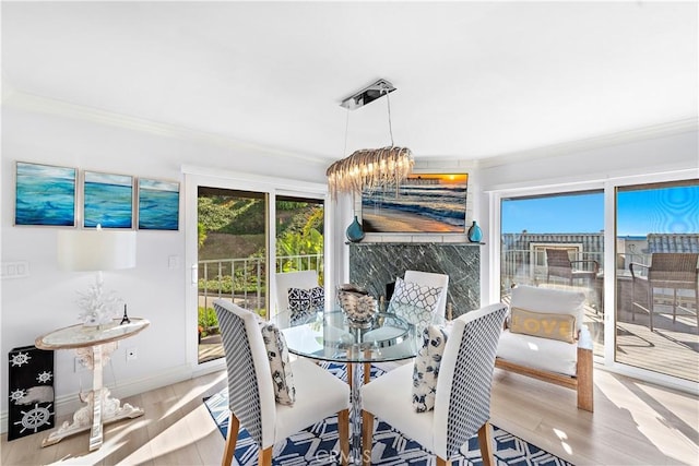 26056 Vista Dr E Unit 64, Dana Point, CA 92624 - dining space featuring wood finished floors, crown molding, and a notable chandelier