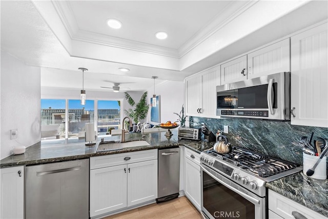 26056 Vista Dr E Unit 64, Dana Point, CA 92624 - kitchen featuring a sink, backsplash, white cabinetry, appliances with stainless steel finishes, and hanging light fixtures