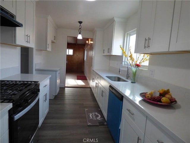 kitchen with light countertops, gas stove, a sink, and dishwashing machine