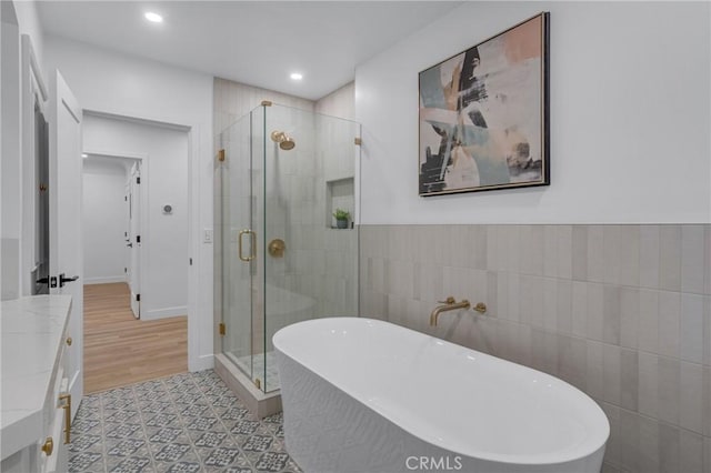 3649 Mount Vernon Dr, View Park, CA 90008 - full bath with tile walls, a shower stall, recessed lighting, vanity, and a freestanding bath