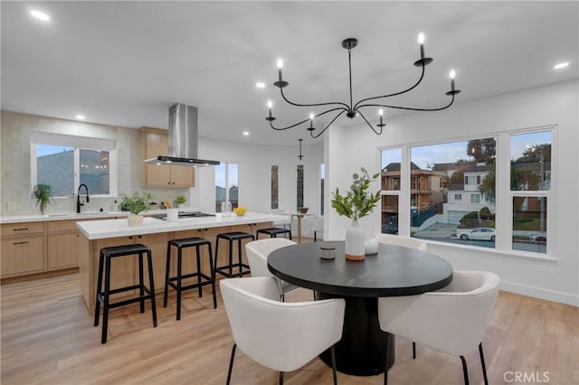 3649 Mount Vernon Dr, View Park, CA 90008 - dining area with a wealth of natural light, light wood-type flooring, recessed lighting, and an inviting chandelier