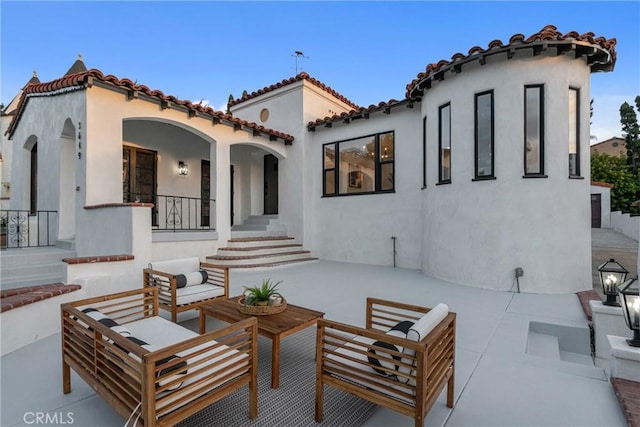3649 Mount Vernon Dr, View Park, CA 90008 - back of property with an outdoor hangout area, stucco siding, and a patio