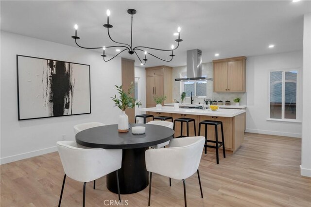 3649 Mount Vernon Dr, View Park, CA 90008 - dining area with a notable chandelier, baseboards, and light wood finished floors