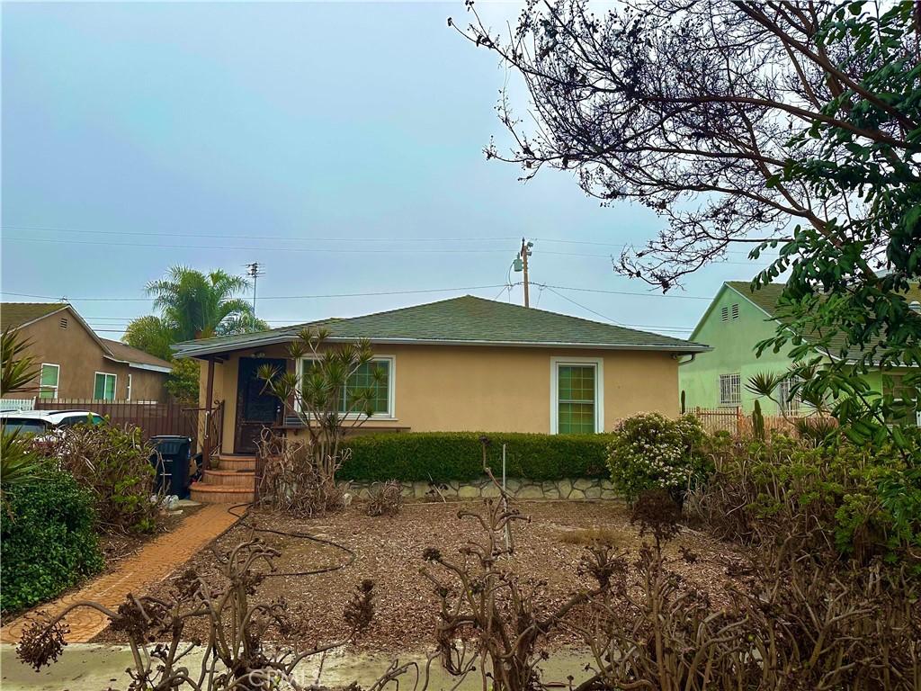 single story home featuring fence, stucco siding, and roof with shingles