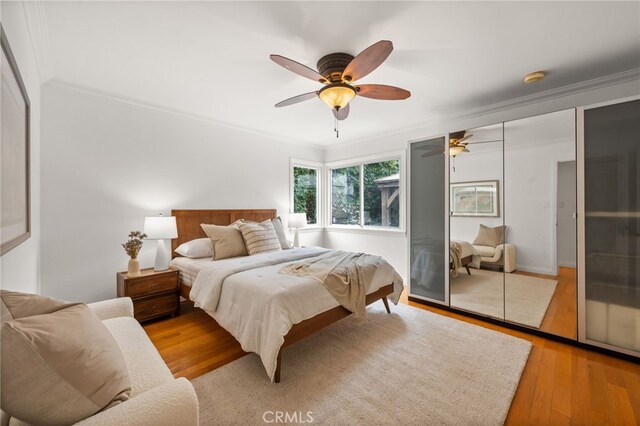 3569 Kelton Ave, Los Angeles, CA 90034 - bedroom featuring crown molding, wood finished floors, ceiling fan, and a closet