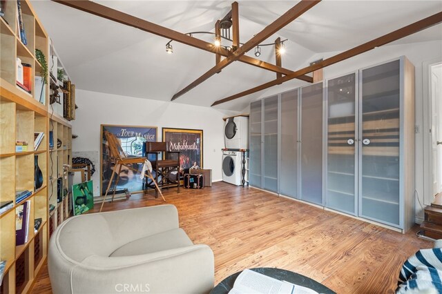 3569 Kelton Ave, Los Angeles, CA 90034 - living room with stacked washer / dryer, vaulted ceiling, and wood finished floors