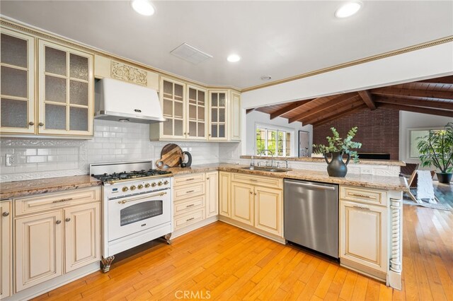 3569 Kelton Ave, Los Angeles, CA 90034 - kitchen with cream cabinetry, stainless steel dishwasher, gas range, under cabinet range hood, and a sink