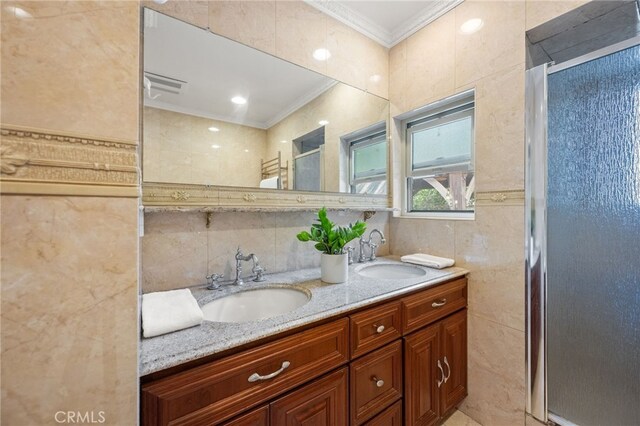 3569 Kelton Ave, Los Angeles, CA 90034 - full bath with crown molding, a stall shower, double vanity, tile walls, and decorative backsplash