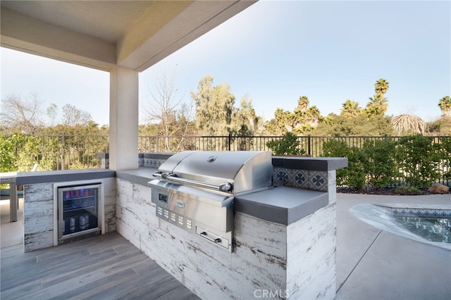 view of patio with exterior kitchen and fence