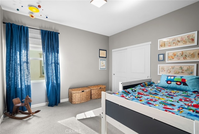 carpeted bedroom with baseboards