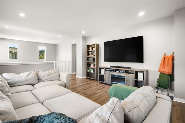 living room with recessed lighting, baseboards, and wood finished floors