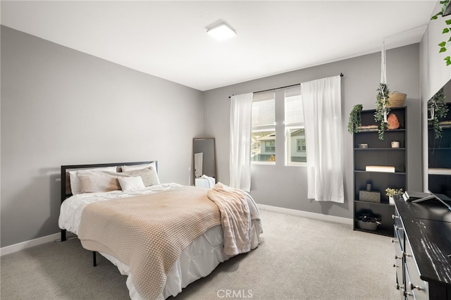 carpeted bedroom featuring baseboards