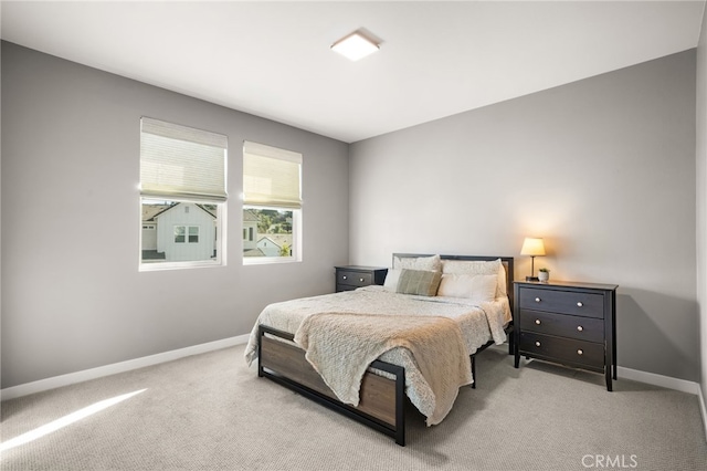 carpeted bedroom featuring baseboards