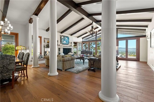 23815 Park Belmonte, Calabasas, CA 91302 - living area with ornate columns, a chandelier, beam ceiling, healthy amount of natural light, and hardwood / wood-style floors